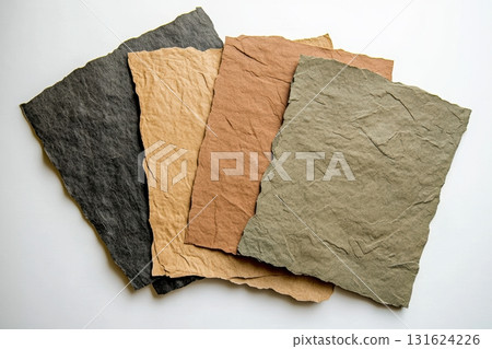 Handmade paper sheets in various colors arranged on a light surface 131624226