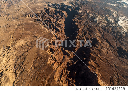 Stunning aerial view of a vast canyon landscape under bright sunlight 131624229