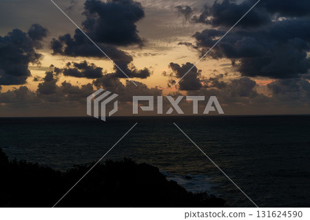 Dawn over the Kumano Sea in Katsuura, Nanki: Clouds rising in the golden sky and the sea surface reflecting a pale light ② Dawn over the Kumano Sea in Katsuura, Nanki: Clouds rising in the golden sky and the sea surface reflecting a pale light ② 131624590