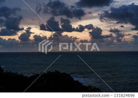 Dawn over the Kumano Sea in Katsuura, Nanki. The golden sky visible through the clouds, the clear color of the sea surface, and the horizon. Dawn over the Kumano Sea in Katsuura, Nanki. The golden sky visible through the clouds, the clear color of the sea surface, and the horizon. 131624696