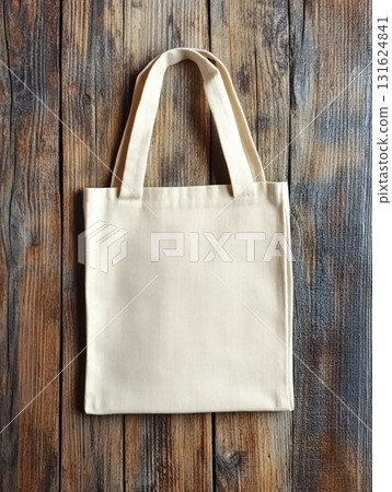 Blank Beige Canvas Tote Bag with Handles on Textured Wooden Surface 131624841