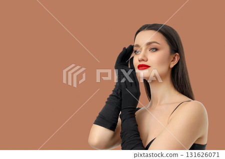 Elegant woman in black gloves, with long dark hair Elegant woman in black gloves, with long dark hair 131626071