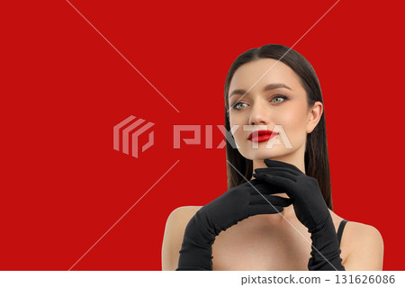 Woman posing with black gloves and bright red lipstick Woman posing with black gloves and bright red lipstick 131626086