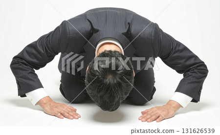 Businessman apologizing by kneeling Businessman apologizing by kneeling 131626539