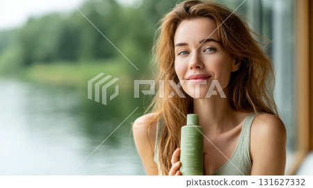 woman holding a light sage green product bottle woman holding a light sage green product bottle 131627332