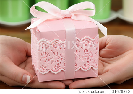Elegant Silver Gift Wrapping for Valentines Day with Delicate Hands in Minty Pink Paper and Lace Elegant Silver Gift Wrapping for Valentines Day with Delicate Hands in Minty Pink Paper and Lace 131628830