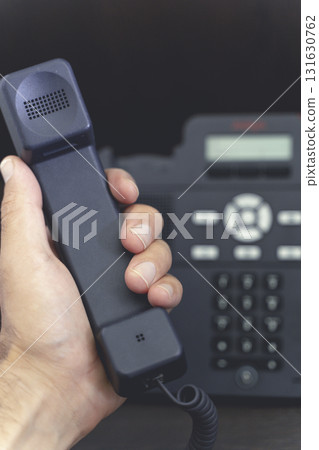 Hand Holding Telephone Handset. Communication and Connection 131630762
