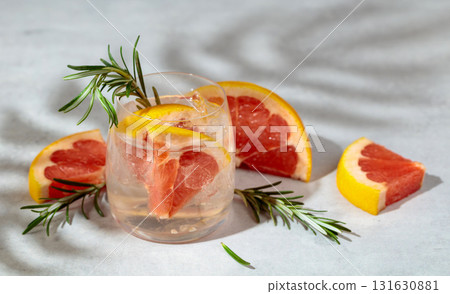 A refreshing summer drink with ice, grapefruit and rosemary. A refreshing summer drink with ice, grapefruit and rosemary. 131630881