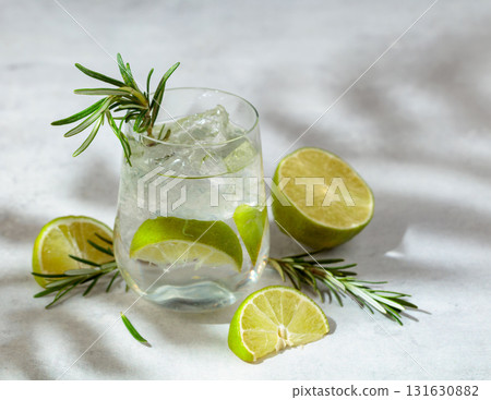 A refreshing summer drink with ice, lime and rosemary. A refreshing summer drink with ice, lime and rosemary. 131630882