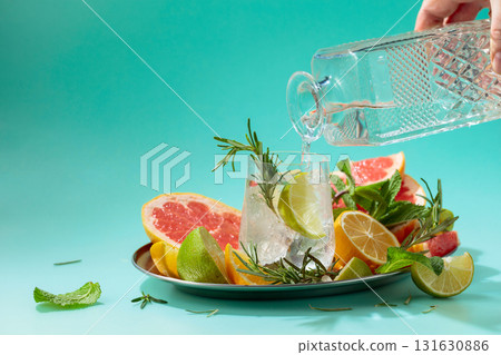 Cocktail with ice, citrus, rosemary and mint. 131630886