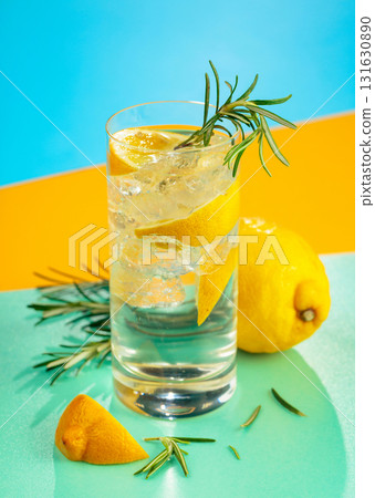 Refreshing cocktail with gin, tonic, lemon, and rosemary. 131630890