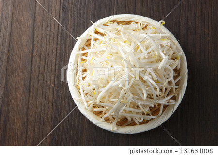 Bean sprouts in a colander with a wood grain background Bean sprouts in a colander with a wood grain background 131631008