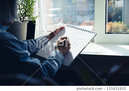 Hands of a senior woman drawing a picture Hands of a senior woman drawing a picture 131631835