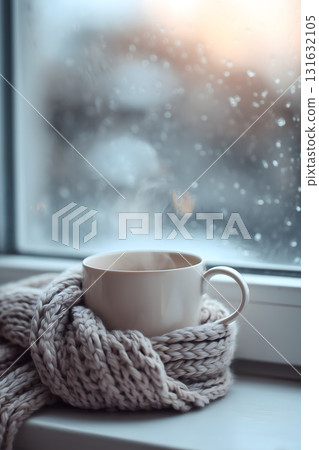 White mug with steam coming out of it is sitting on a knit scarf White mug with steam coming out of it is sitting on a knit scarf 131632105