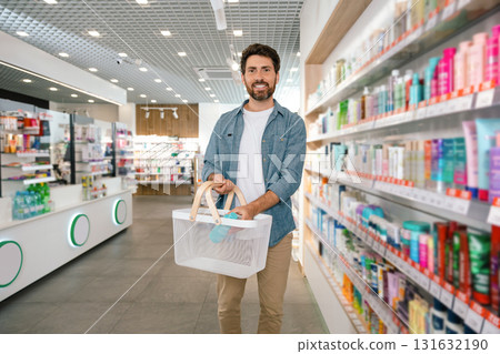 Bearded shopper choosing products in pharmacy Bearded shopper choosing products in pharmacy 131632190