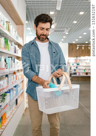 Man browsing pharmacy shelf for medicine Man browsing pharmacy shelf for medicine 131632197