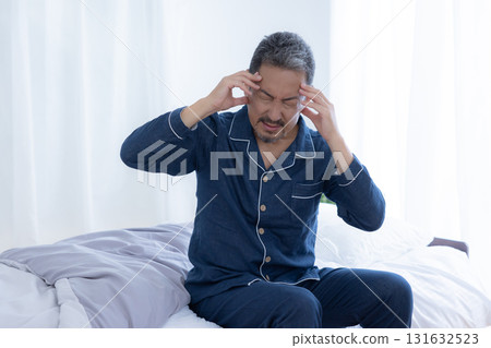 Headache Middle-aged man holding his head Headache Middle-aged man holding his head 131632523