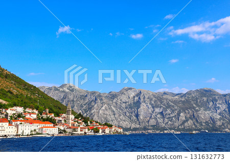 Picturesque view of embankment with old houses, mountains and Adriatic sea, Perast, Montenegro. Beautiful scene with medieval houses and seascape. Topic of summer vacation, travel, cruises and tours Picturesque view of embankment with old houses, mountains and Adriatic sea, Perast, Montenegro. Beautiful scene with medieval houses and seascape. Topic of summer vacation, travel, cruises and tours 131632773