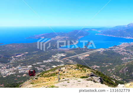 A cable car in Montenegro. Aerial view of picturesque cableway and Bay of Kotor. Top view on Tivat, mountains and Adriatic Sea, Montenegro. Bird's-eye view of Gulf of Kotor, view from Mount Lovcen 131632779