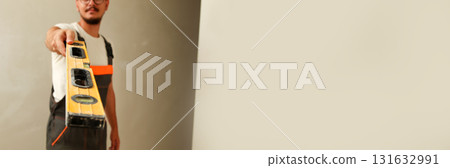 banner image of a construction worker focused on precision, using a level to check alignment. A uniformed worker man uses a leveling tool, with the clean white background banner image of a construction worker focused on precision, using a level to check alignment. A uniformed worker man uses a leveling tool, with the clean white background 131632991
