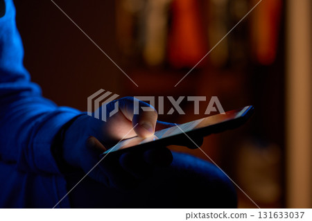 Hand using smartphone in dark room Hand using smartphone in dark room 131633037