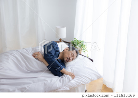 Bedroom: Middle-aged man sleeping soundly Bedroom: Middle-aged man sleeping soundly 131633169