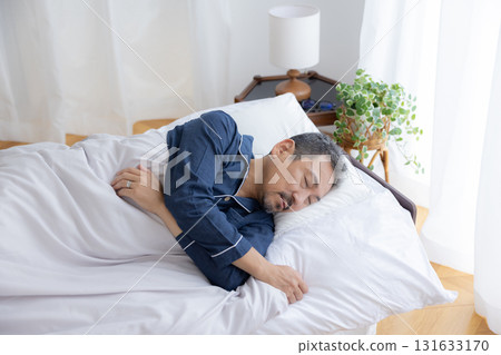 Bedroom: Middle-aged man sleeping soundly 131633170