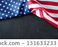 United States flag on black backdrop with copy space, great for banners, posters, and digital designs for patriotic events such as Independence Day, Veterans Day, Labor Day,Memorial Day. 131633233