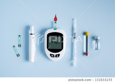 Set of diabetic tools glucometer, insulin bottle, syringe, and lancet for blood testing, medical equipment. Diabetes testing concept, world diabetes day background. Set of diabetic tools glucometer, insulin bottle, syringe, and lancet for blood testing, medical equipment. Diabetes testing concept, world diabetes day background. 131633235