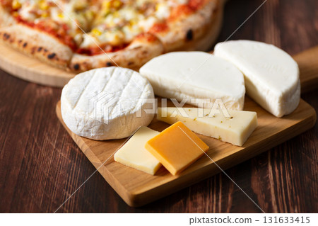 Cheese platter and pizza 131633415