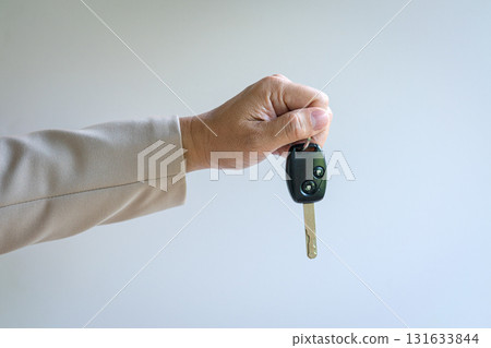 Man holding a car key. Man holding a car key. 131633844
