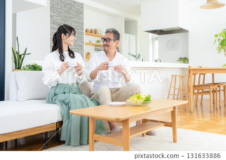 A middle-aged couple relaxing in the living room A middle-aged couple relaxing in the living room 131633886