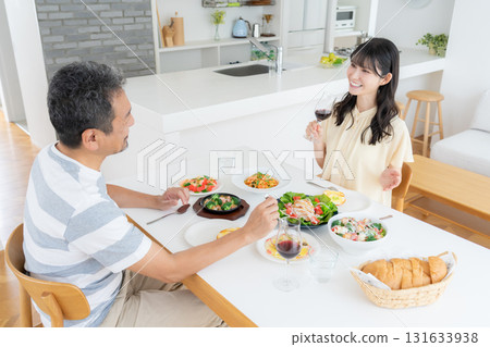 A middle-aged couple eating in the dining room 131633938