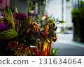 Bright flowers and gold paper decorations offered at a Taiwanese temple 131634064