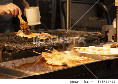 Grilled whole squid at a Taiwanese food stall Grilled whole squid at a Taiwanese food stall 131634253