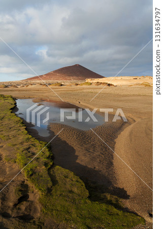 Montana Roja mountain on Tenerife coast near El Medano, Canary Islands, Spain, sunny summer day Montana Roja mountain on Tenerife coast near El Medano, Canary Islands, Spain, sunny summer day 131634797