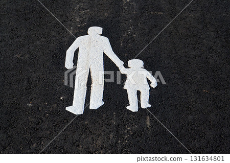 Sidewalk sign depicting walking adult holding a childs hand on the streets of Gothenburg, Sweden, sunny summer day, 15 minute city concept Sidewalk sign depicting walking adult holding a childs hand on the streets of Gothenburg, Sweden, sunny summer day, 15 minute city concept 131634801