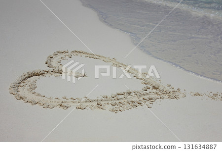 Heart drawn in the sand. Beach background. Top view 131634887