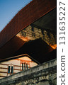Low angle view of modern metallic museum building reflecting traditional architecture in Krakow, Poland, during golden hour. Metallic museum facade mirroring traditional architectural details 131635227