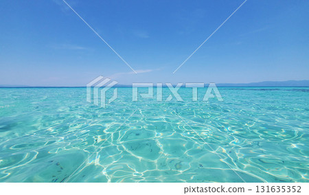 The clear turquoise water of a warm sea under a clear blue sky 131635352