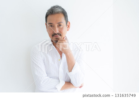 Middle-aged man doing skin care in the living room Middle-aged man doing skin care in the living room 131635749