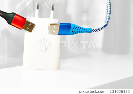 Two red blue usb cables,charger on white 131636353