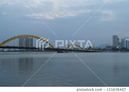Dragon Bridge in Da Nang Vietnam steel dragon architecture over Han River with LED lights sky reflection and scenic coastal river view 131636487