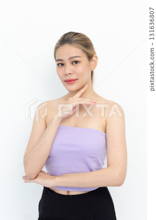 Skin care. Woman with beauty face touching healthy facial skin portrait. Beautiful smiling asian girl model with natural makeup touching glowing hydrated skin on white background Skin care. Woman with beauty face touching healthy facial skin portrait. Beautiful smiling asian girl model with natural makeup touching glowing hydrated skin on white background 131636807