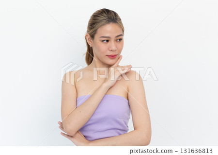 Skin care. Woman with beauty face touching healthy facial skin portrait. Beautiful smiling asian girl model with natural makeup touching glowing hydrated skin on white background 131636813