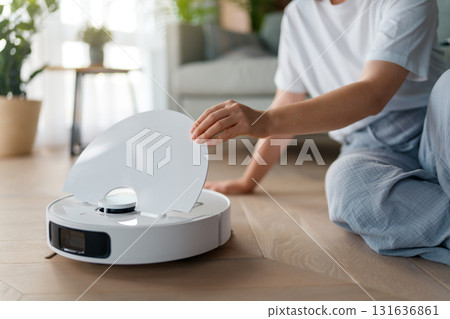 White robotic vacuum cleaner on wooden floor White robotic vacuum cleaner on wooden floor 131636861