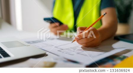 Woman architect is working on plans Woman architect is working on plans 131636924