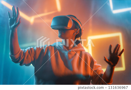 Woman with VR virtual reality goggles 131636967