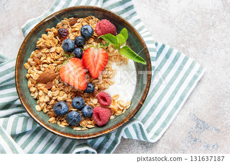 Granola bowl with yogurt, berries, and mint Granola bowl with yogurt, berries, and mint 131637187