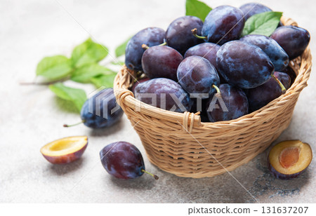Fresh plums in wicker basket, healthy eating concept 131637207